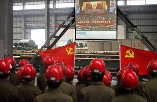 Рабочие в городе Чжуцзи смотрят трансляцию открытия 18 съезда Компартии Китая, на котором Си Цзиньпин был избран генсеком. 8 ноября 2012 года