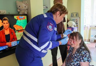 Медики в квартире пострадавшей от обстрела жительницы Донецка. 21 мая 2024 года