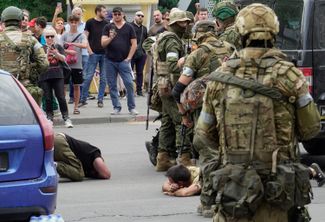 According to reports from the outlet Bloknot (which Meduza cannot verify), Wagner fighters stopped a vehicle with a license plate from the self-declared “Luhansk People’s Republic” (LNR) and made the men inside the vehicle lay on the ground.