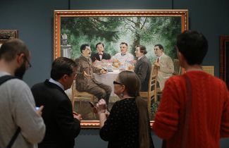 Vistors to the Alexander Gerasimov exhibition contemplate “The Artists at Stalin's Dacha.”