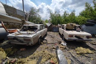 Разбитые автомобили на территории АЗС, куда попала российская авиабомба