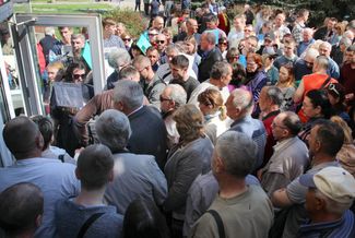 People line up at the opening of Luhansk’s first passport center for processing Russian citizenship applications