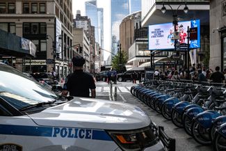 Guests arrive for the ceremony in black SUVs, passing through several security points. July 3, 2026