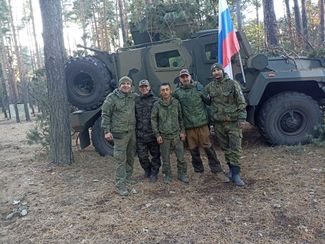 Deputy commander Vladislav Iselkov, commander Rasulzhon Makhmudov, and Ilya Bakharev in Hrechyshkyne
