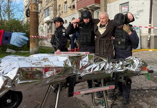 Police officers evacuate a wounded resident from a damaged house in the Dnieper, April 25, 2026.
