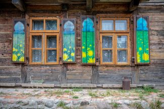 Painted wooden shutters on a wooden house in Kruszyniany. June 2018.