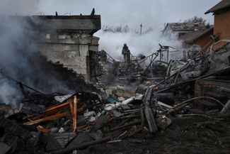 Спасатели у дома в частном секторе Днепра, сильно пострадавшего в результате российского ракетного обстрела города