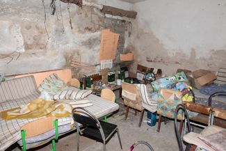 The same basement in Yahidne, located 140 kilometers (or about 90 miles) north of Kyiv, not far from the Belarusian border. Yahidne was occupied by the Russian troops in March 2022, during their attempt to capture Kyiv. Among the people confined in the basement <a href="https://meduza.io/news/2023/02/08/mobilizovannyh-iz-tuvy-pozhalovavshihsya-na-izbieniya-voennymi-dnr-perevedut-v-55-yu-brigadu-voennosluzhaschih-etogo-podrazdeleniya-podozrevayut-v-ubiystve-mirnyh-ukraintsev" rel="noopener noreferrer" target="_blank">were</a> infants and people over the age of 90. According to Ukraine’s then-Prosecutor General Iryna Venediktova, 10 people died in the basement, and 17 more Yahidne residents were killed by the occupying army. Later, Ukraine <a href="https://meduza.io/news/2022/06/08/genprokuror-ukrainy-soobschila-o-dele-protiv-devyati-rossiyskih-voennyh-ih-podozrevayut-v-prestupleniyah-v-sele-v-chernigovskoy-oblasti" rel="noopener noreferrer" target="_blank">charged</a> nine servicemen of the Russian 55th detached motorized rifle brigade with war crimes.