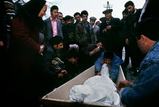 Family members prepare a body for burial in Aghdam, Azerbaijan, following the massacre in nearby Khojaly. February 1992.