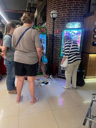 Sevastopol residents charge their phones in a shopping mall. June 25