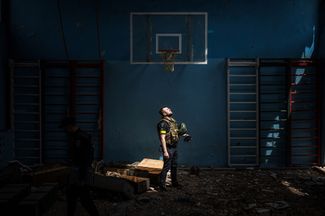 Украинский полицейский в спортивном зале школы, где, по словам жителей, базировались российские солдаты в селе Ольховка
