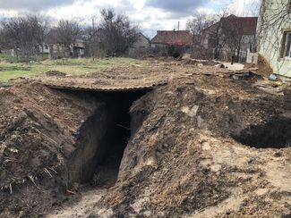 Trenches dug by Russian soldiers near private homes in Bohdanivka. April 11, 2022