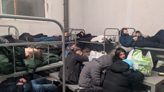 Twenty-eight people trying to sleep in an eight-person holding cell