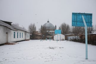 The courtyard outside of School No. 10 and the mosque next door. Tokmok, Kyrgyzstan. January 2023.