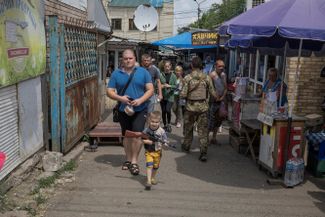 Мальчик с игрушечным автоматом на рынке города Константиновка Донецкой области. Он находится под украинским контролем и постоянно подвергается обстрелам со стороны России<br>