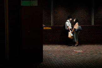 Пара в токийском метро, 14 июля 2021 года.