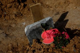 Sneakers worn by one of the victims of the earthquake, on her grave