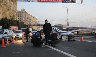 Forensic investigators work at the scene where former State Duma deputy Ruslan Yamadayev was assassinated on the Smolensk Embankment in Moscow.