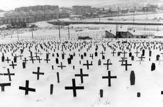 The graves of Bosnian Muslims, Serbs, and Croats at the Zetra Olympic Hall arena, which was built for the 1984 Winter Olympics in Sarajevo. 1994.