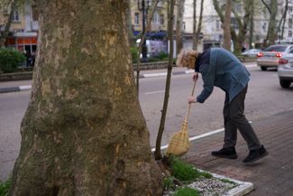 A Tuapse resident cleans the sidewalk, April 24, 2026