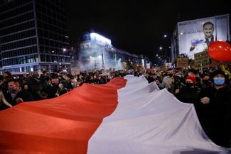 Протестующие с национальным флагом Польши. Варшава, 30 октября 2020 года