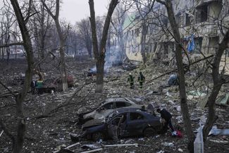 Украинские спасатели возле разрушенной больницы в Мариуполе. 9 марта 2022 года