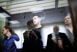 Vyacheslav Kryukov, Ruslan Kostylenkov, and Pyotr Karamzin during the sentencing. 