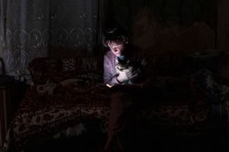Borodyanka resident Tatyana Safonova and her cat, Asya, when the lights went out, October 20, 2022.