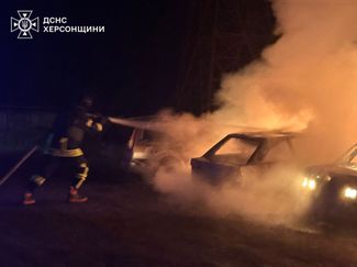 Rescuers extinguish a fire after an attack in the Kherson region, May 10, 2026. No injuries