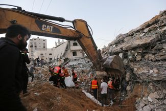 Поисковые работы среди обломков рухнувшего дома, разрушенного в результате авиаударов армии Израиля по городу Бейт-Лахия. 13 мая 2021 года