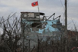 A flag with an image of Putin flies over a destroyed building in Avdiivka. February 2024. 