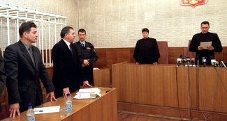 Grigorii Pasko (first from the left) hears his sentence in the Pacific Fleet court