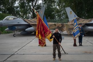 Volodymyr Zelensky stands in front of two F-16s at the Air Forces Day ceremony. August 4, 2024.