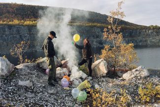 Natalia and her brother build a fire on the hills in the middle of Murmansk