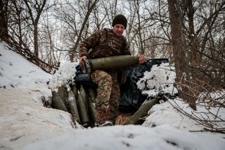 Боец 406-й артиллерийской бригады ВСУ несет снаряд для гаубицы М777