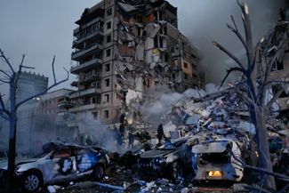 Emergency workers clear the rubble after a Russian rocket hit a <a href="https://meduza.io/en/feature/2023/02/23/dispatch-from-dnipro" rel="noopener noreferrer" target="_blank">residential building in Dnipro</a>, leaving many people trapped under debris. January 14, 2023.