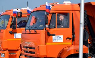 Путин за рулем самосвала торжественно открывает автомобильное движение по Крымскому мосту. 15 мая 2018 года