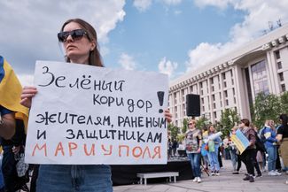 A woman with a sign calling for a humanitarian corridor out of Mariupol. Kyiv, May 3, 2022