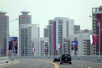 Russian flags and banners with images of Vladimir Putin on the streets of Pyongyang, North Korea 