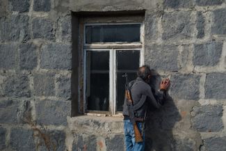 A man kisses the walls of his home in Karvachar, Nagorno-Karabakh, before abandoning it. November 12, 2020. (The Karvachar district was ceded to Azerbaijan under the 2020 peace agreement with Armenia.)