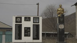 Left: A memorial to the victims of the Second World War in Kana.Right: A shiny black plaque with a portrait of Stalin and the message “Thank you for the victory!” (a recent addition)
