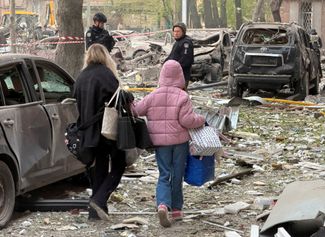 Residents at the site of a Russian raid on a house in the Dnieper, April 25, 2026