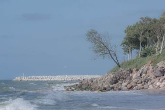 Coastal protection structures near the Liepāja treatment plant: the new pier (seen in the background), fragments of the old gabion, and boulders. July 2024.