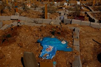 The grave of seven-year-old Elif Yasar.  A dress with the effigy of the heroine of the cartoon 