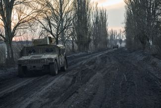 Military vehicles on a mud road near Avdiivka. February 14, 2024. 