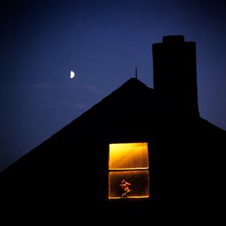 Луна в фазе первой четверти и освещенное окно мансарды частного дома, 1980-е года.