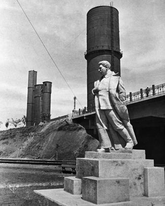 A statue of Joseph Stalin on the grounds of a steel mill in Mariupol. USSR, 1940.