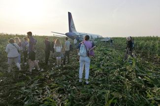 Passengers from Ural Airlines Flight A321 after an emergency landing in a cornfield not far from Moscow’s Zhukovsky International Airport on August 15, 2019. The successful landing became known as the “<a href="https://meduza.io/en/feature/2019/08/15/295-feet-to-save-233-lives" target="_blank">Miracle on the Cornfield</a>,” in a nod to a controlled ditching after a bird strike in the Hudson River, about a decade earlier.