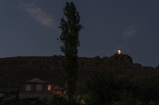 Крест в армянском приграничном городе Чамбарак. За последние десятилетия появилось много подобных крестов, особенно в сельской местности. Они видны с дороги — и светятся только ночью. Некоторые жители Чамбарака говорят, что намеренно проезжают мимо этого креста, прежде чем отправиться домой.