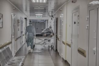 A patient in the hallway of the “red zone”
